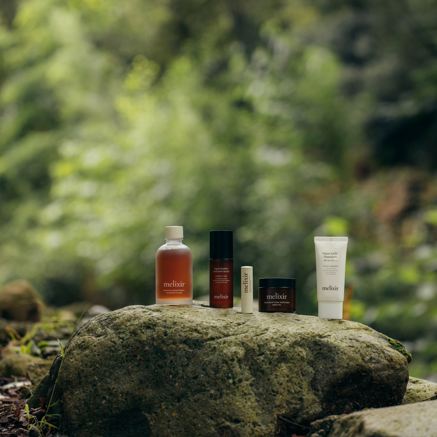 melixir vegan products standing on a rock in a korean forest