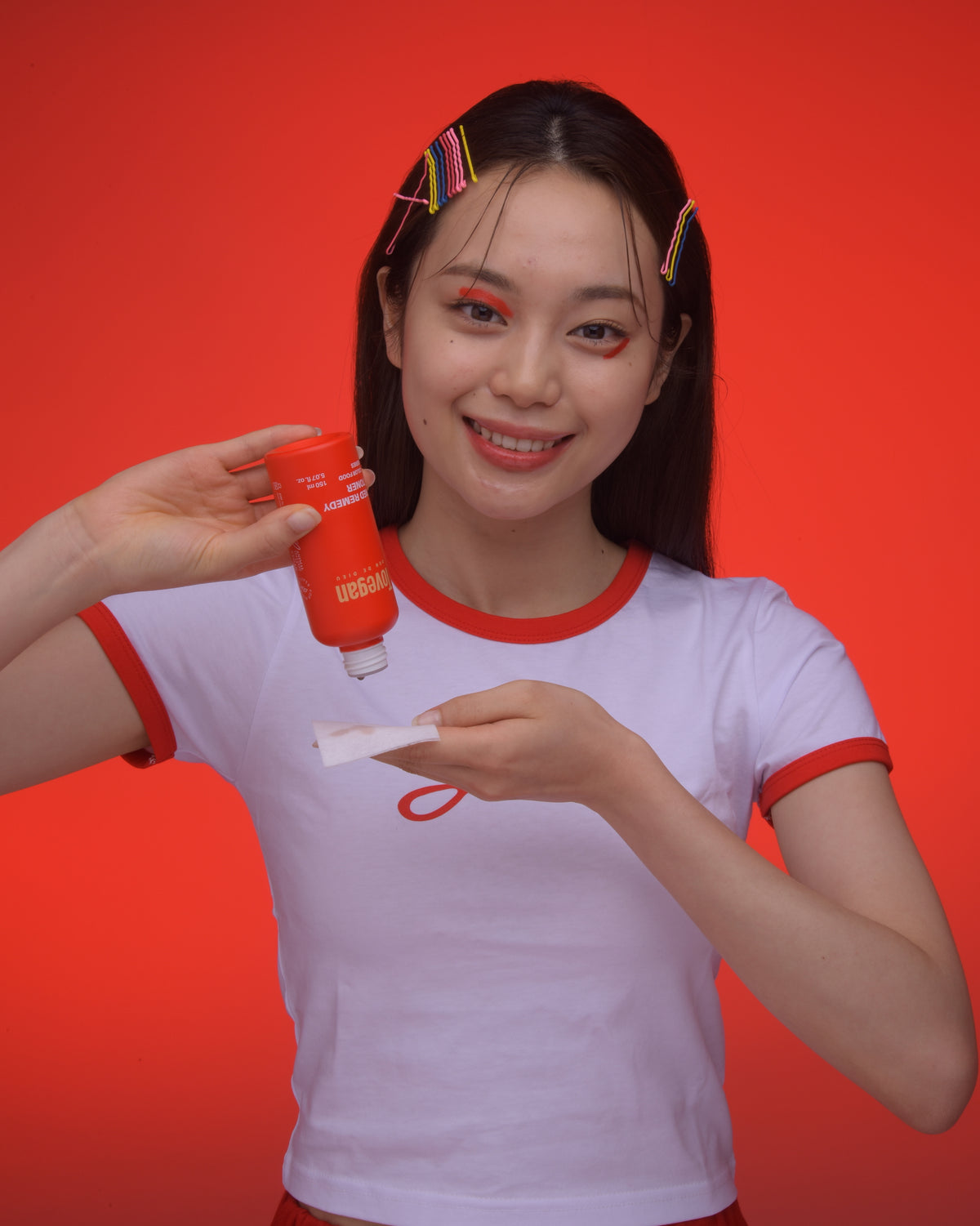 korean model applies tovegan red remedy toner on cotton pad